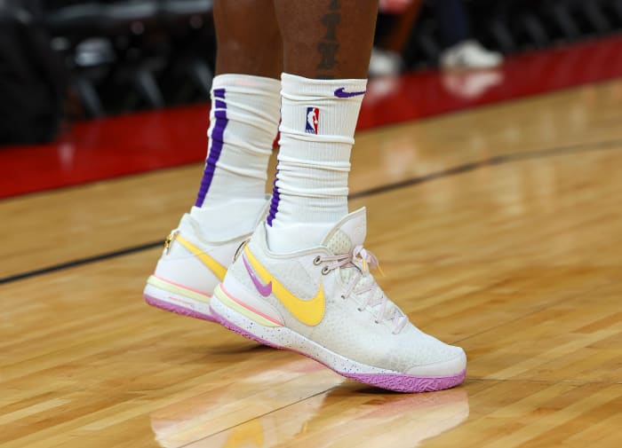 View of white, yellow, and purple Nike LeBron shoes.